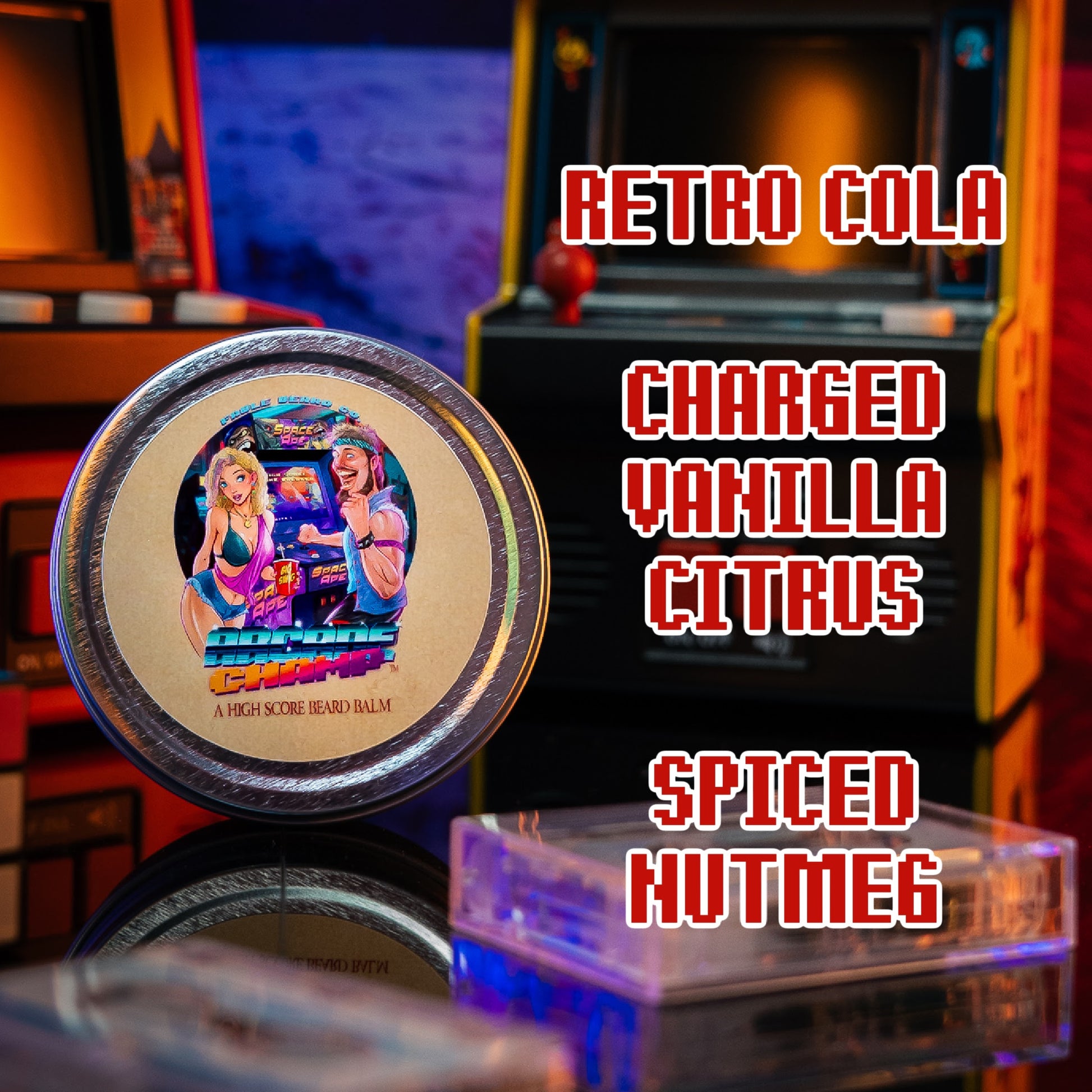 A round tin of Retro Cola Charged Vanilla Citrus Spiced Nutmeg hand cream is shown in a retro arcade machine setting. The tin features a colorful retro illustration 
