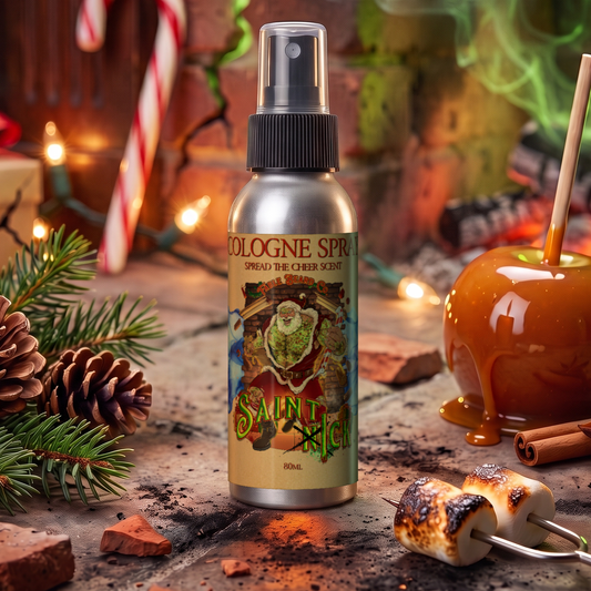 Saint Ick Cologne 80 ml spray bottle in Caramel Apple Cider, Campfire S'mores and Evergreen Essence scent beside a caramel apple, pine cones and toasted s'mores, Fable Beard Co.